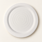Front of a white Break A Plate celebration plate with concentric rings